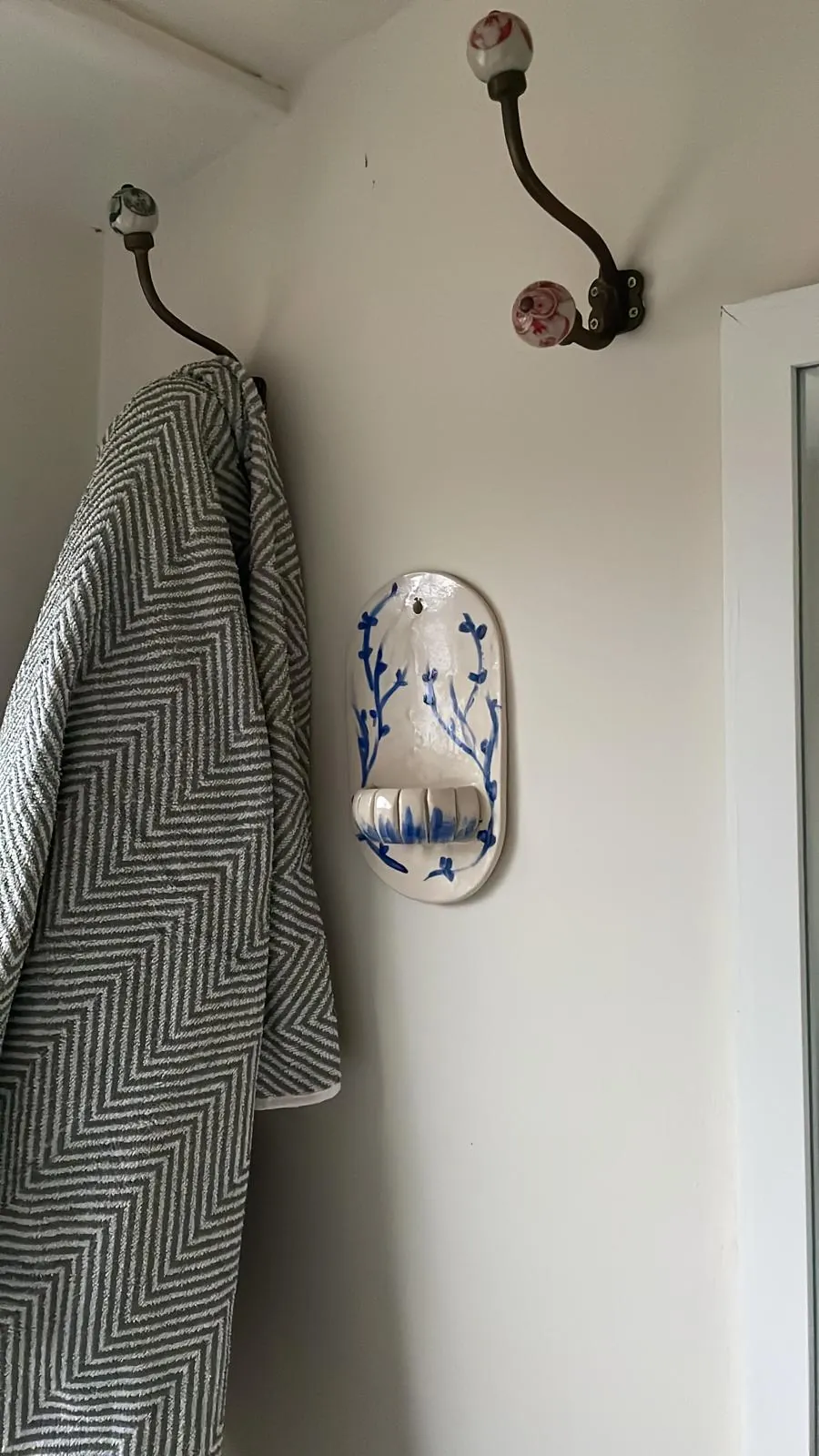 Small Sconce mounted on wall, wide view, in situ